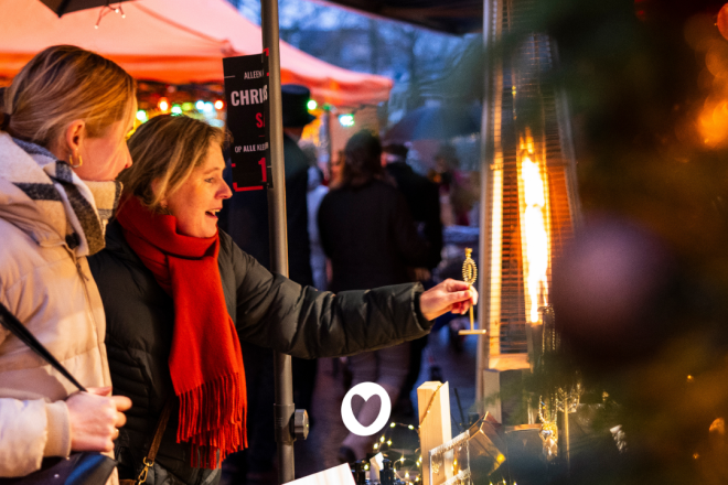 Two women enjoy the Winterfestival Ommen on Saturday, December 13, 2025, surrounded by warm lights.
